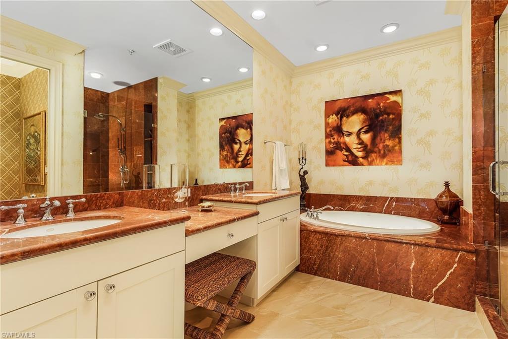 780 5th Avenue South, Unit 3 Naples, FL 34102 - Photo 17 of 28 a bathroom with a double vanity sink and a bathtub