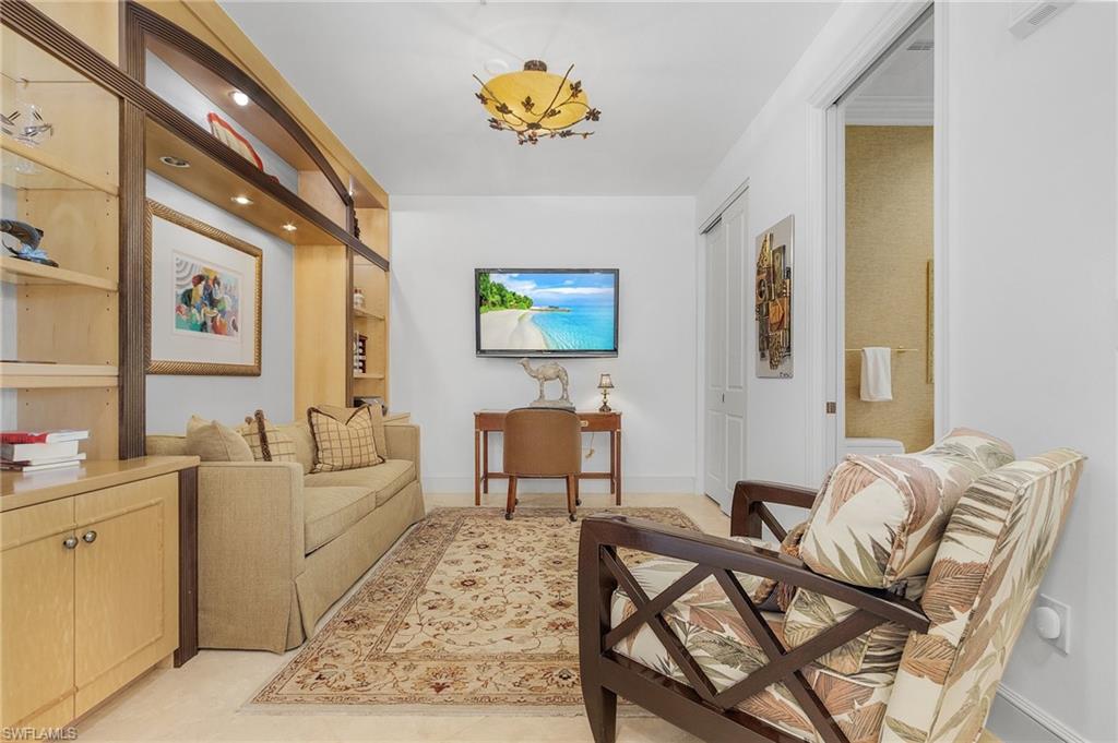 780 5th Avenue South, Unit 3 Naples, FL 34102 - Photo 22 of 28 a living room with furniture and a table