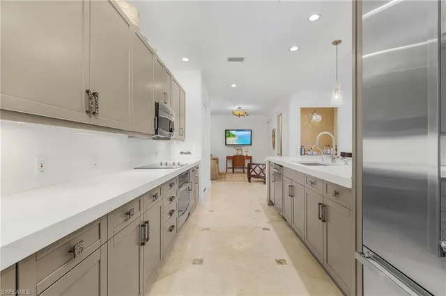 a large kitchen with stainless steel appliances kitchen island granite countertop a sink and cabinets