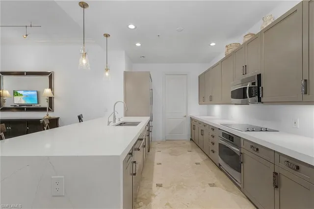 a kitchen that has a sink a stove and a microwave