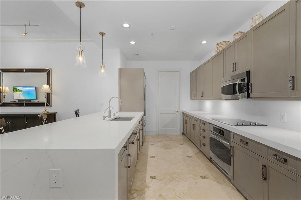780 5th Avenue South, Unit 3 Naples, FL 34102 - Photo 6 of 28 a kitchen that has a sink a stove and a microwave