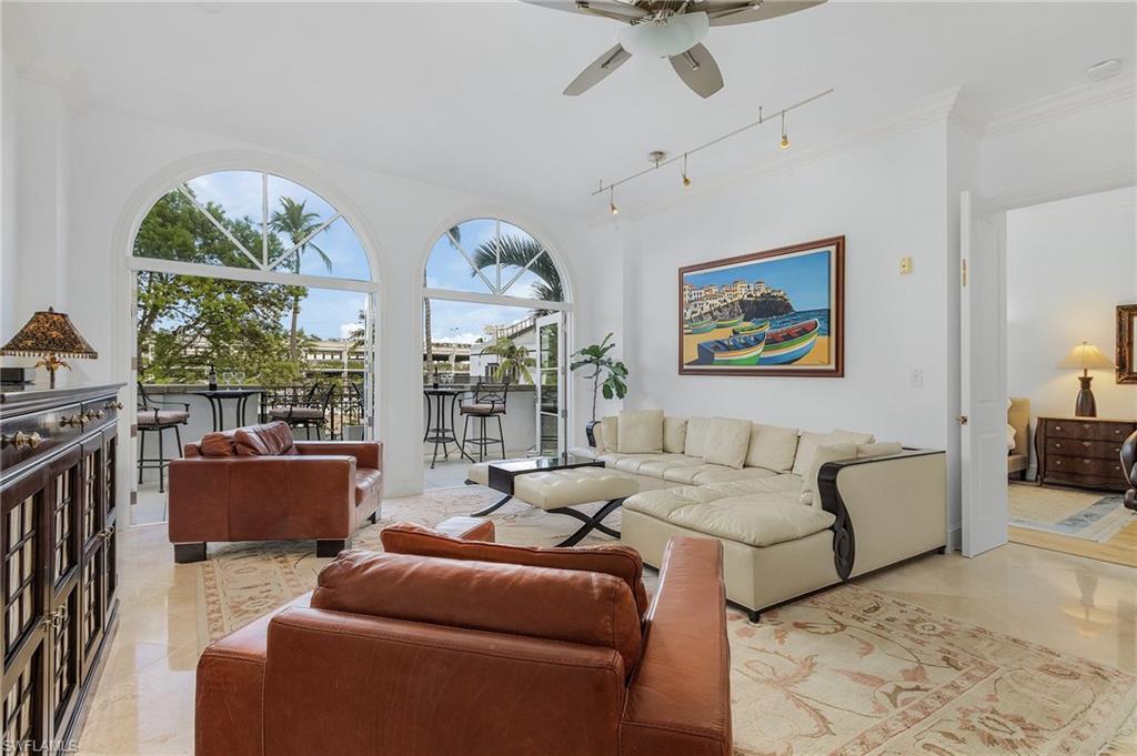 780 5th Avenue South, Unit 3 Naples, FL 34102 - Photo 8 of 28 a living room with furniture fireplace and a large window