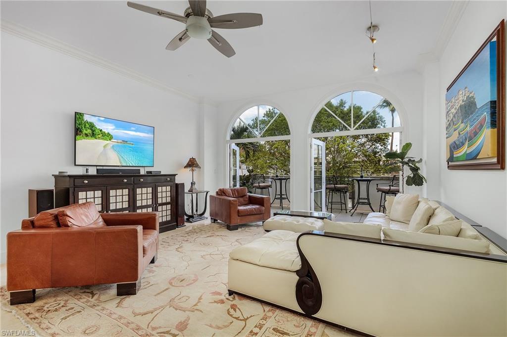 780 5th Avenue South, Unit 3 Naples, FL 34102 - Photo 10 of 28 a living room with furniture a floor to ceiling window and a flat screen tv