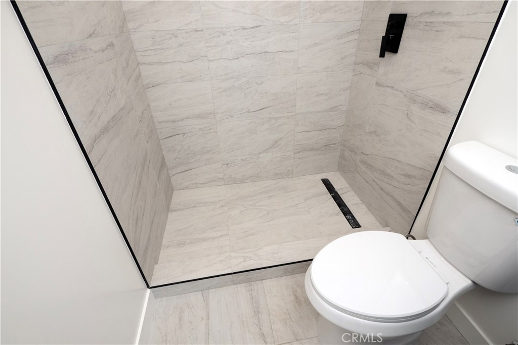 1571 Ricardo Street, Unit 2 Los Angeles, CA 90033 - Photo 9 of 29 a bathroom with a toilet and a mirror