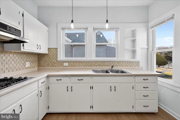 a kitchen with a sink and cabinets