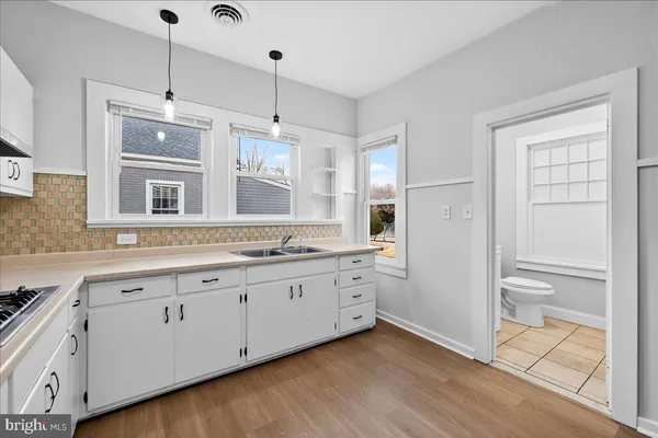 a spacious bathroom with a granite countertop sink mirror and a shower
