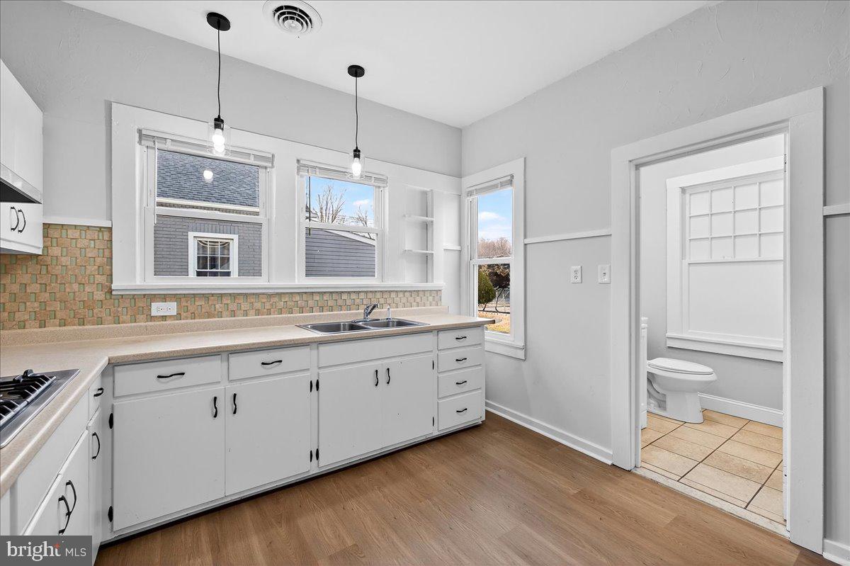 615 13th Street New Castle, DE 19720 - Photo 15 of 39 a spacious bathroom with a granite countertop sink mirror and a shower