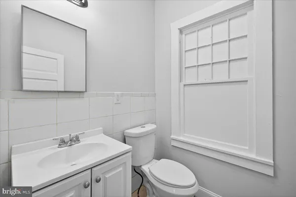 a bathroom with a sink a toilet and vanity