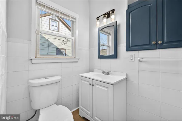a bathroom with a toilet sink and mirror