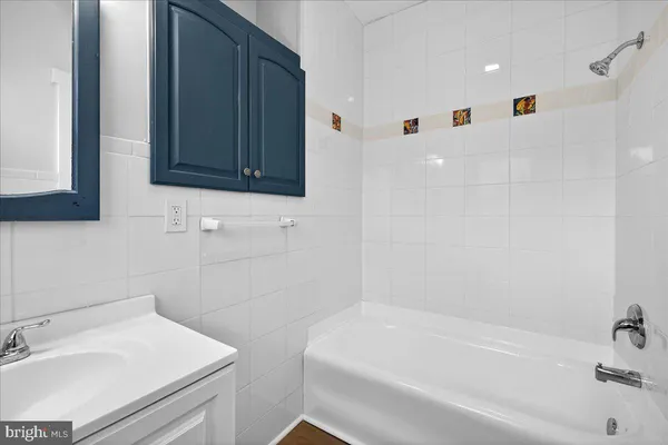 a bathroom with a sink a toilet and bathtub