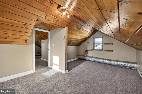 a view of a room with wooden walls
