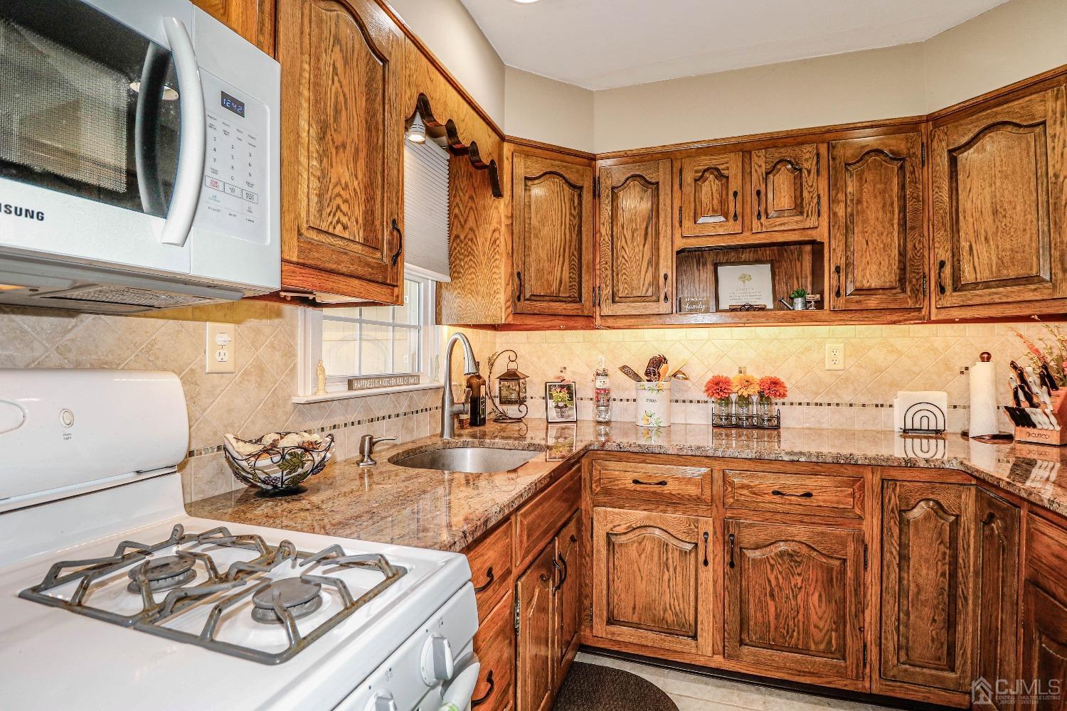 3 Frances Road Edison, NJ 08820 - Photo 16 of 33 a kitchen with stainless steel appliances granite countertop a sink stove and cabinets