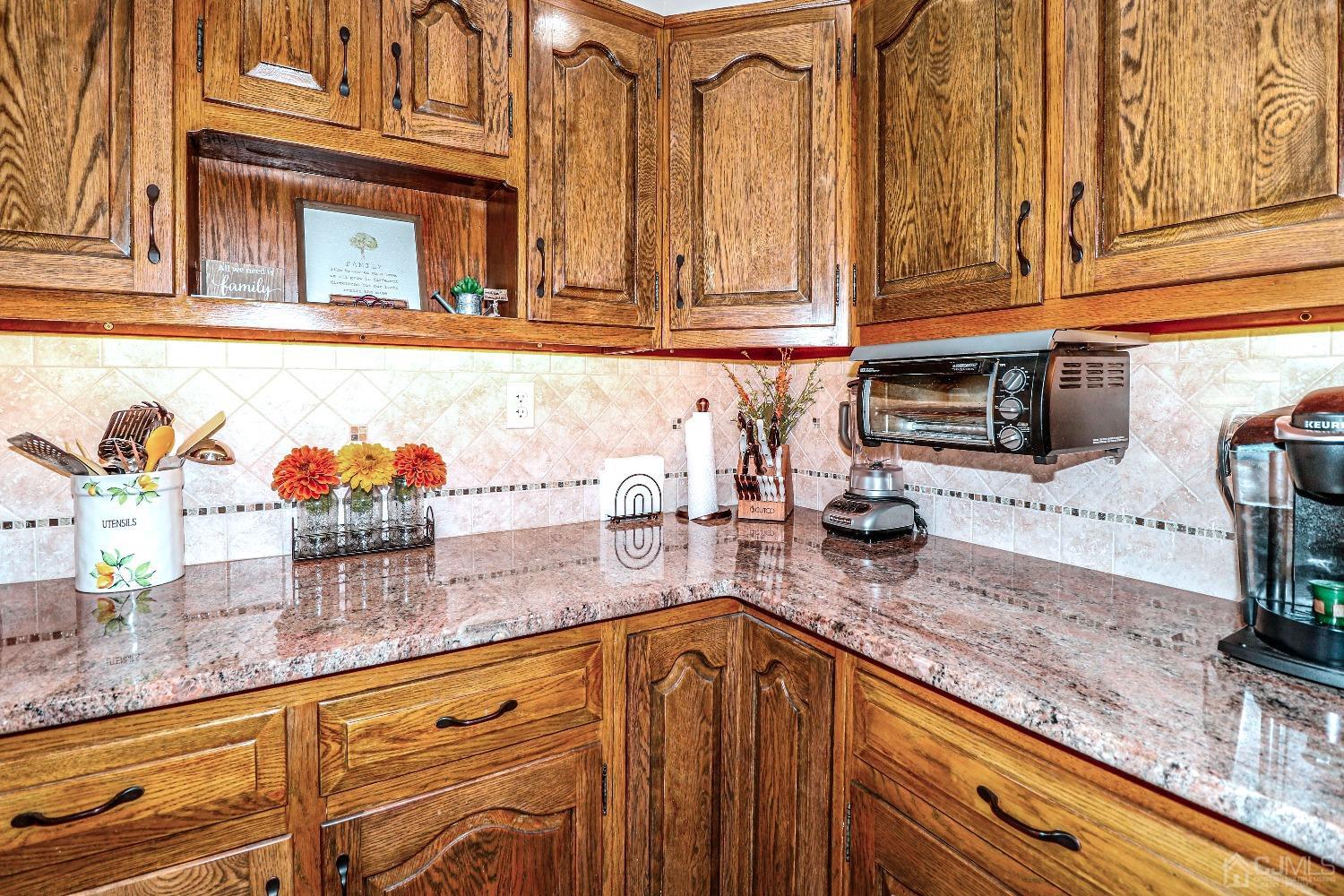 3 Frances Road Edison, NJ 08820 - Photo 17 of 33 a kitchen with stainless steel appliances granite countertop a sink and dishwasher wooden cabinets with granite countertops