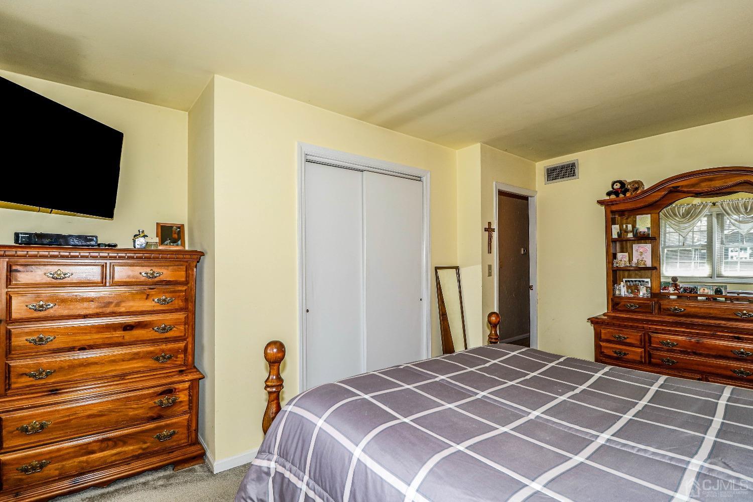 3 Frances Road Edison, NJ 08820 - Photo 25 of 33 a bedroom with a bed and a flat screen tv