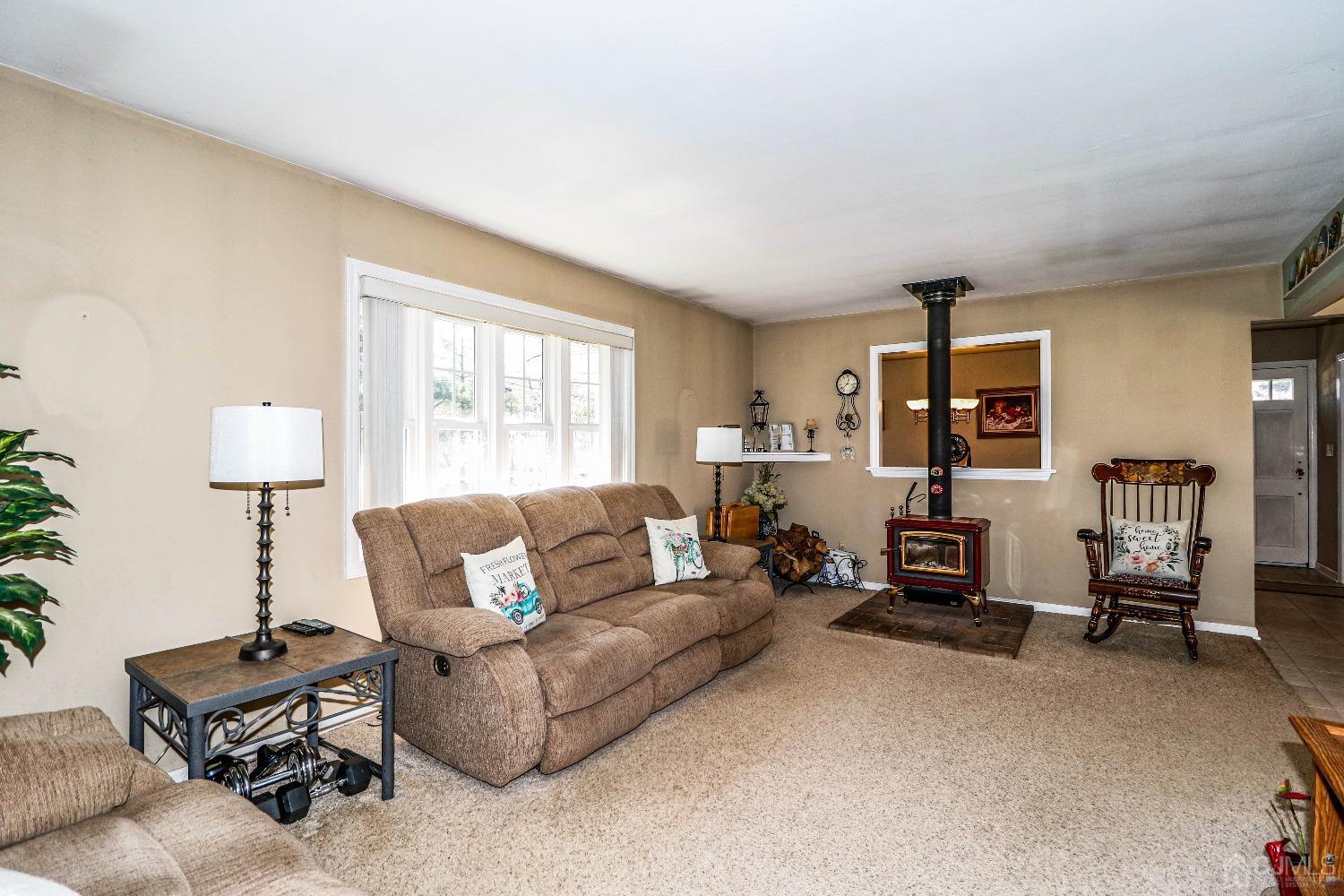 3 Frances Road Edison, NJ 08820 - Photo 10 of 33 a living room with furniture a lamp and a window