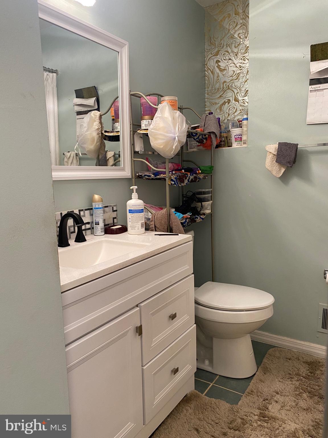 7907 Good Luck Road Lanham, MD 20706 - Photo 11 of 36 a bathroom with a toilet sink and mirror