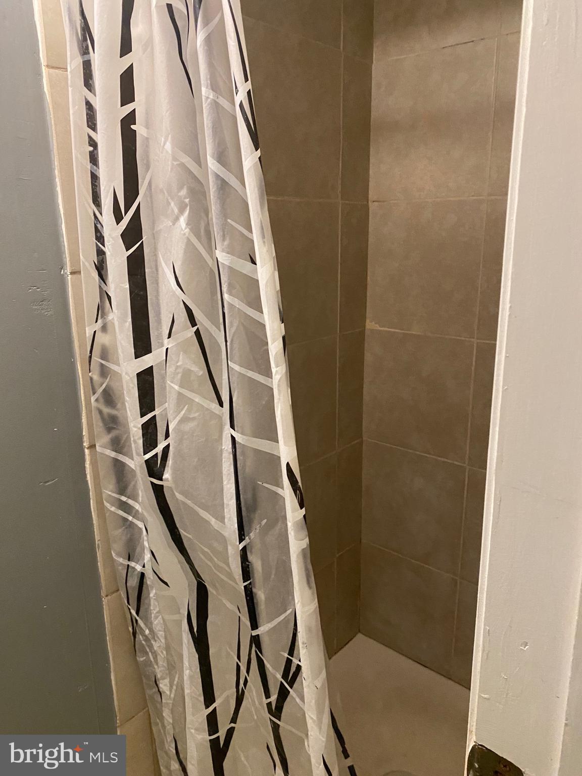 7907 Good Luck Road Lanham, MD 20706 - Photo 22 of 36 a bathroom with a shower toilet and a window