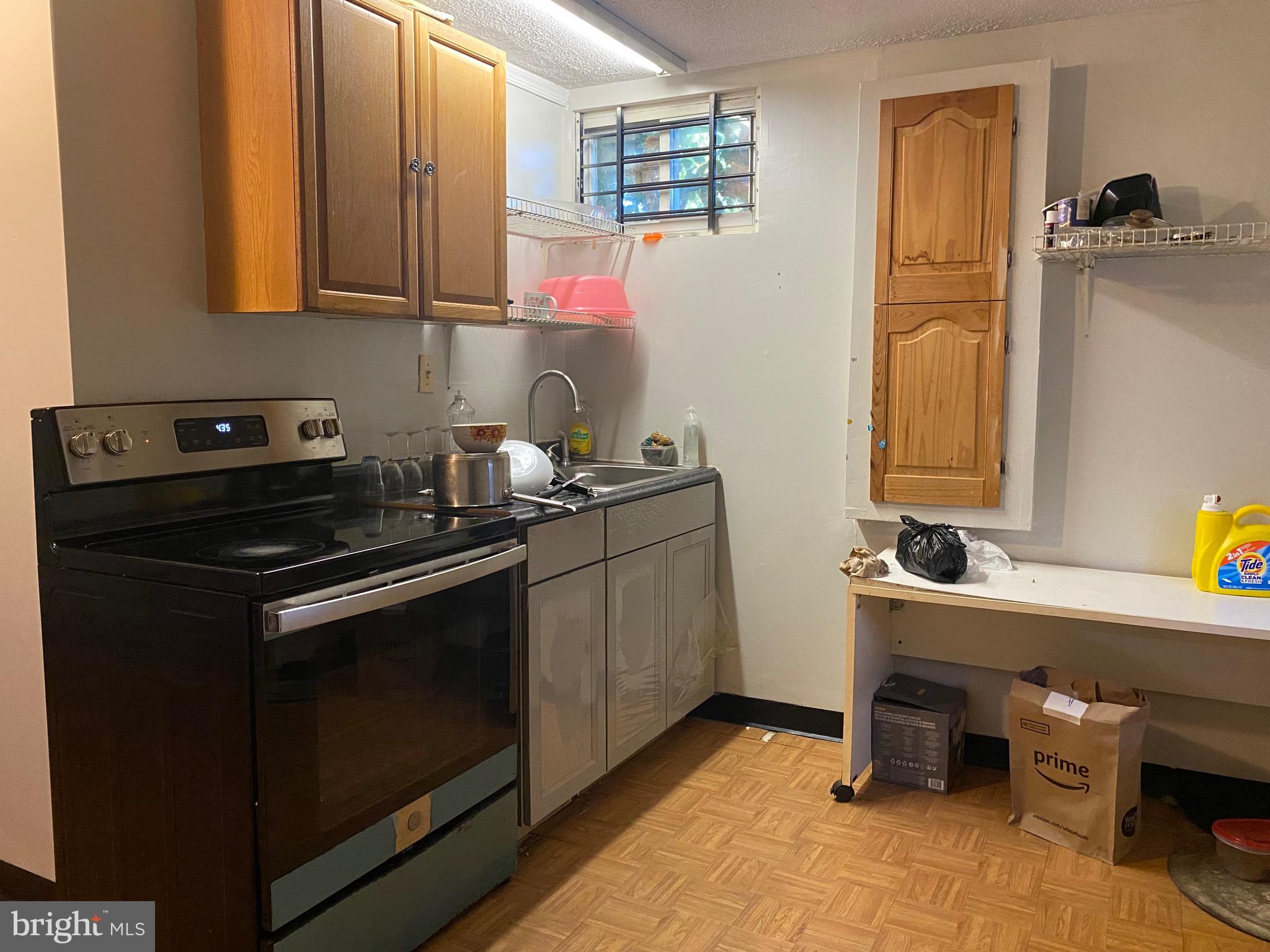 7907 Good Luck Road Lanham, MD 20706 - Photo 30 of 36 a kitchen with a sink cabinets and wooden floor