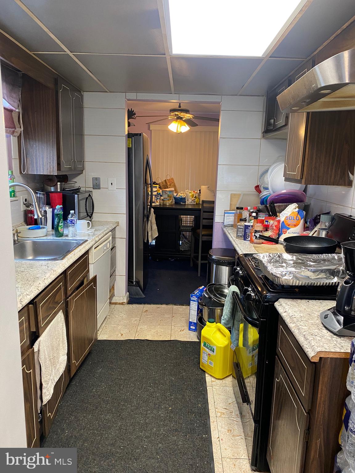 7907 Good Luck Road Lanham, MD 20706 - Photo 5 of 36 a kitchen with stainless steel appliances kitchen island granite countertop a sink and cabinets