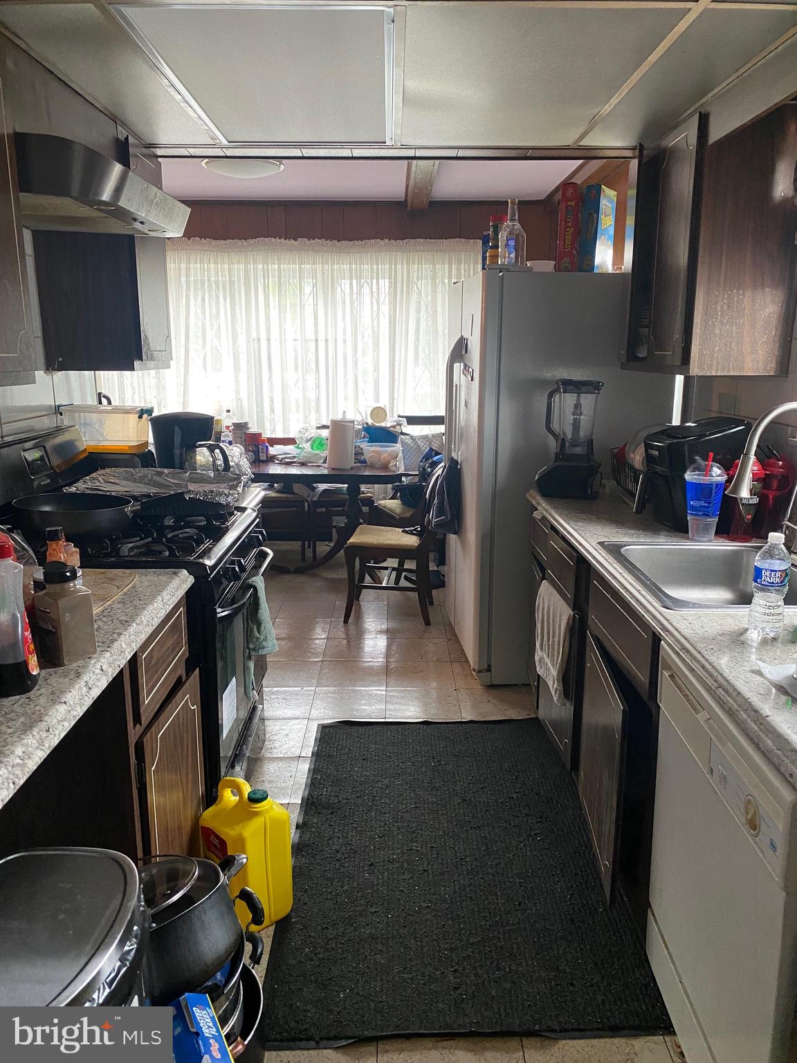 7907 Good Luck Road Lanham, MD 20706 - Photo 6 of 36 a kitchen with stainless steel appliances granite countertop a sink a stove and a refrigerator