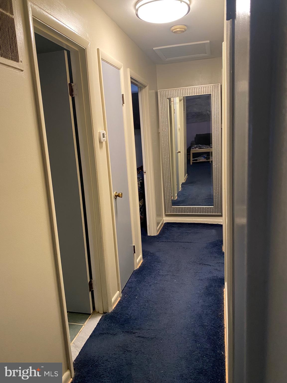 7907 Good Luck Road Lanham, MD 20706 - Photo 9 of 36 a view of a hallway with wooden floor and a bathroom