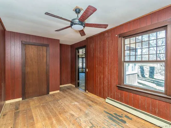 a view of a livingroom with a ceiling fan and window