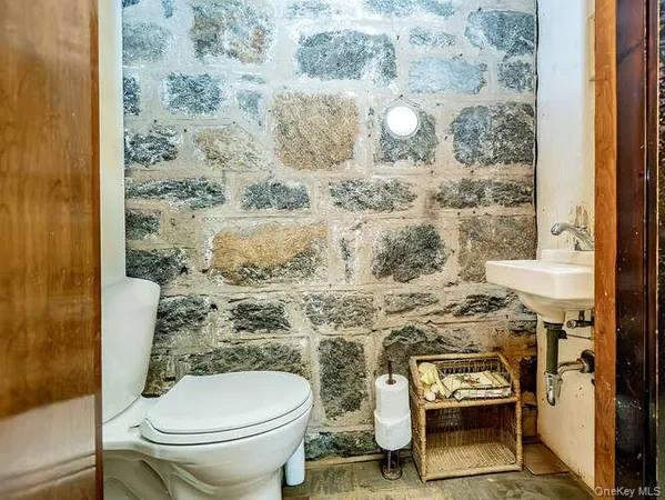 a bathroom with a toilet and a shower curtain