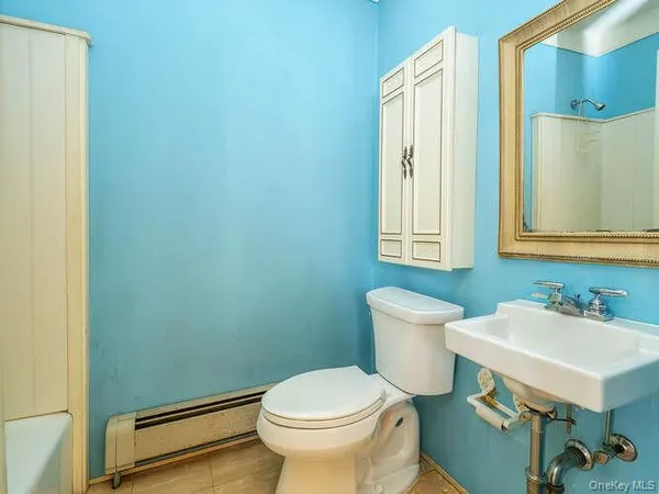 a bathroom with a sink toilet and a mirror