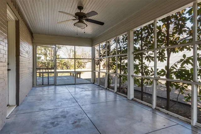 a park view with a bench and trees with wooden floor and a yard