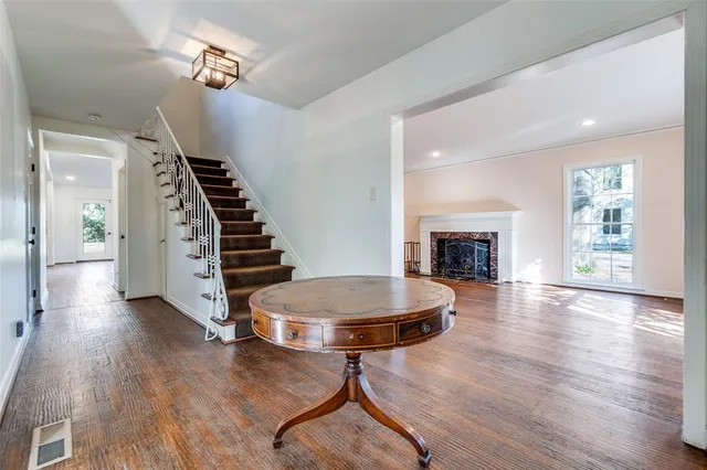a living room with furniture a fireplace and wooden floor