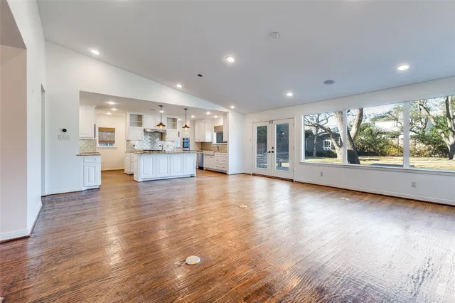 a view of a living room and kitchen with furniture wooden floor and kitchen