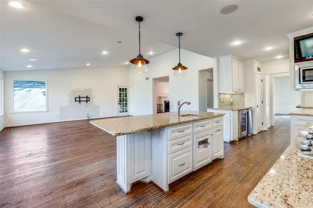 a large kitchen with stainless steel appliances kitchen island a large island in the center