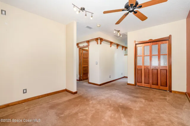 a view of empty room with ceiling fan