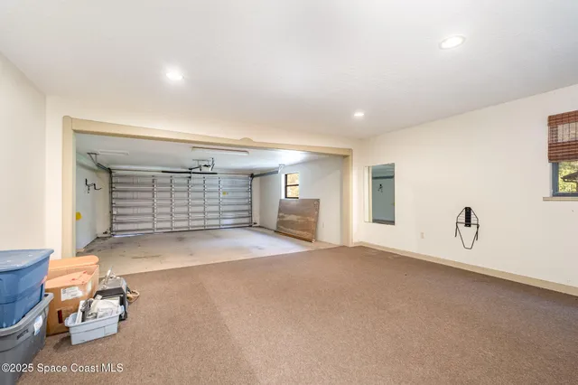 a front view of a house with a garden and sitting area