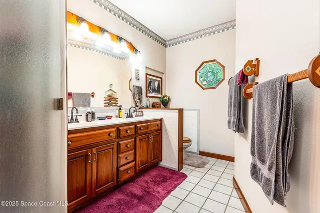 a large kitchen with stainless steel appliances granite countertop a refrigerator and a sink