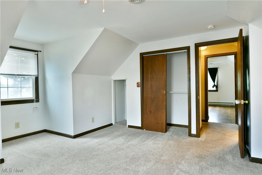 1141 Howell Road East Palestine, OH 44413 - Photo 41 of 41 Bonus room featuring light carpet, lofted ceiling, and baseboard heating