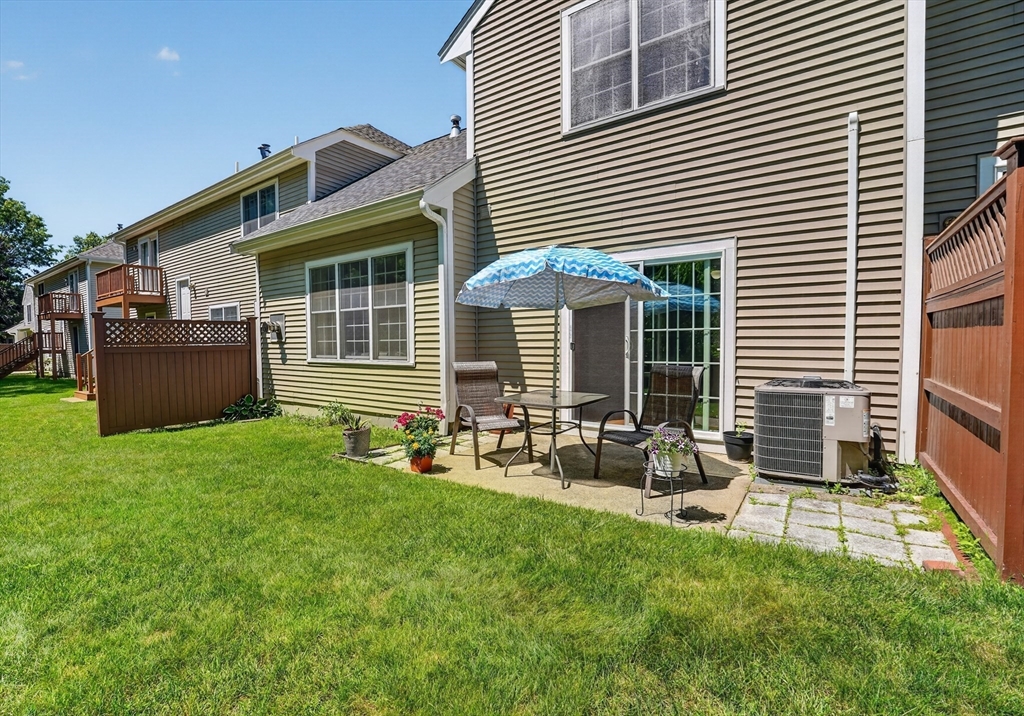 15 Evergreen Circle, Unit 15 Canton, MA 02021 - Photo 24 of 29 a front view of house with yard and outdoor seating