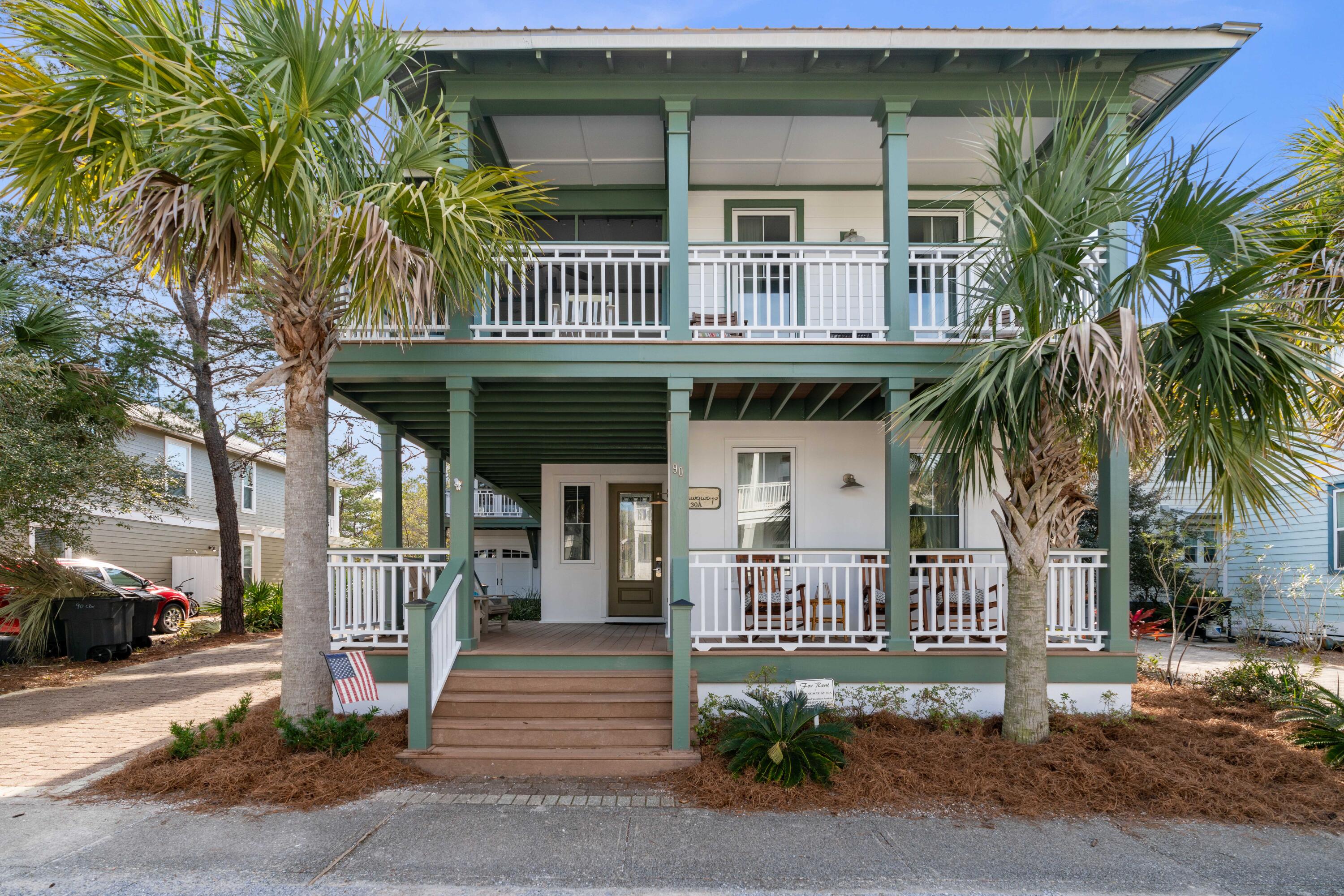 90 West Cobia Run Inlet Beach, FL 32461 - Photo 3 of 37 a view of a brick house with large windows and a small yard