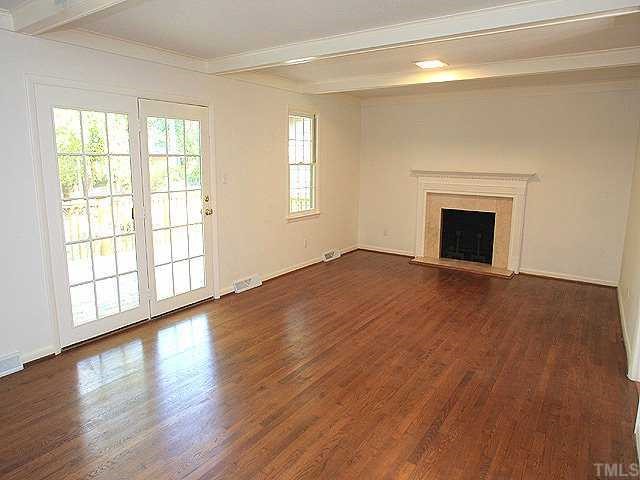 4001 Brevard Place Raleigh, NC 27609 - Photo 5 of 12 wooden floor fireplace and windows in an empty room