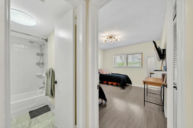 a bedroom with a bed window and a chair