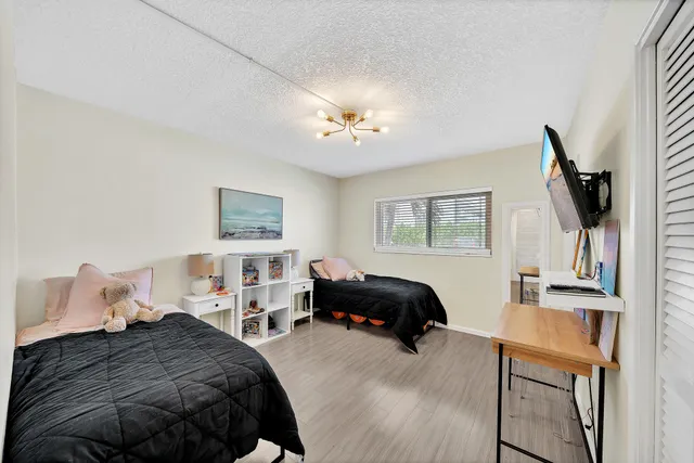 a bedroom with a bed and a chandelier