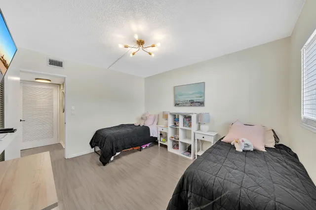 a view of bathroom with toilet washing machine and a shower