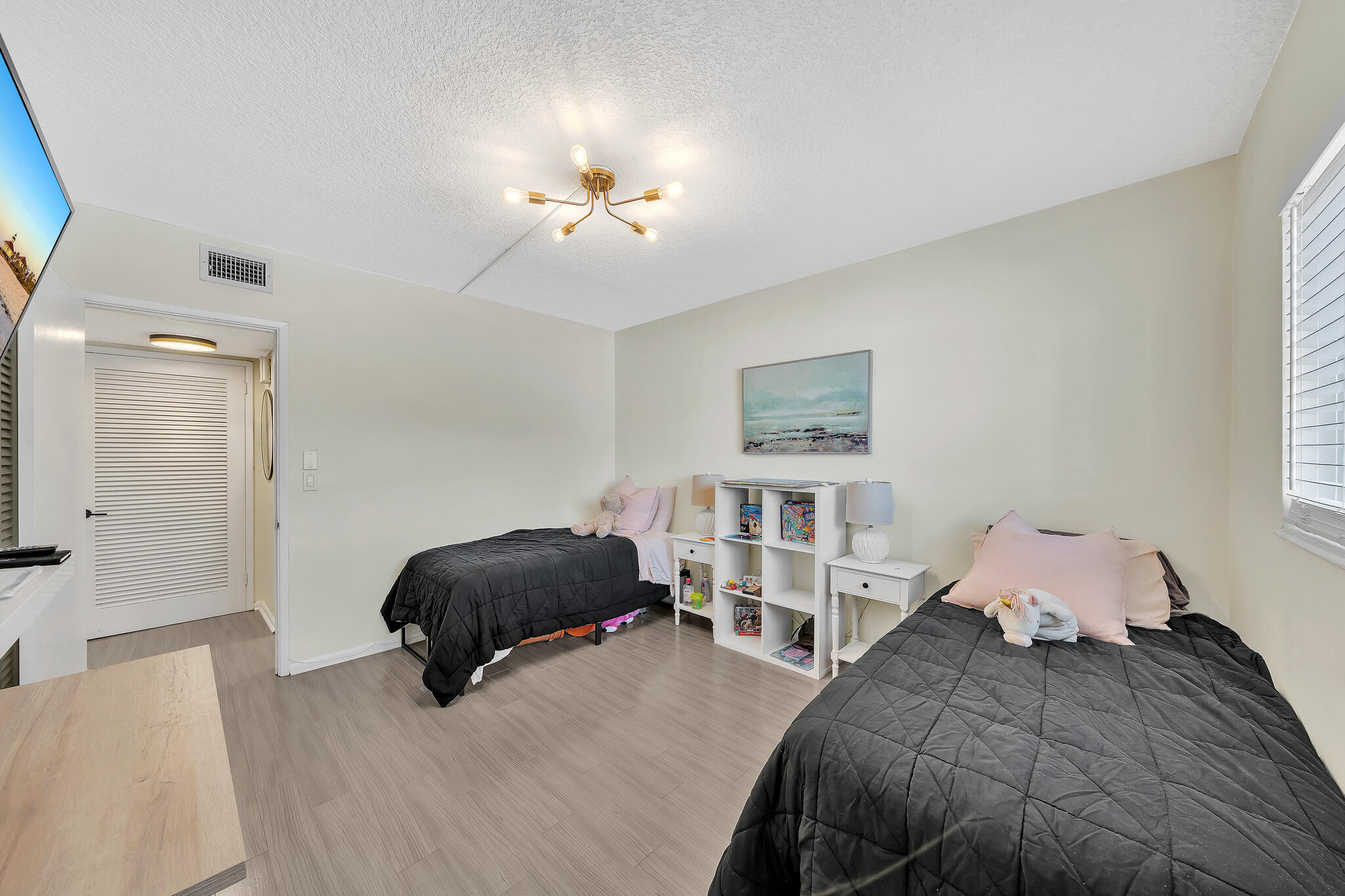 711 Northeast Harbour Terrace, Unit 3090 Boca Raton, FL 33431 - Photo 13 of 53 a bedroom with a bed and a chandelier