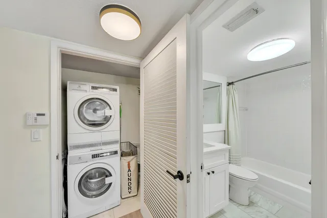 a bathroom with a bathtub shower sink vanity and toilet