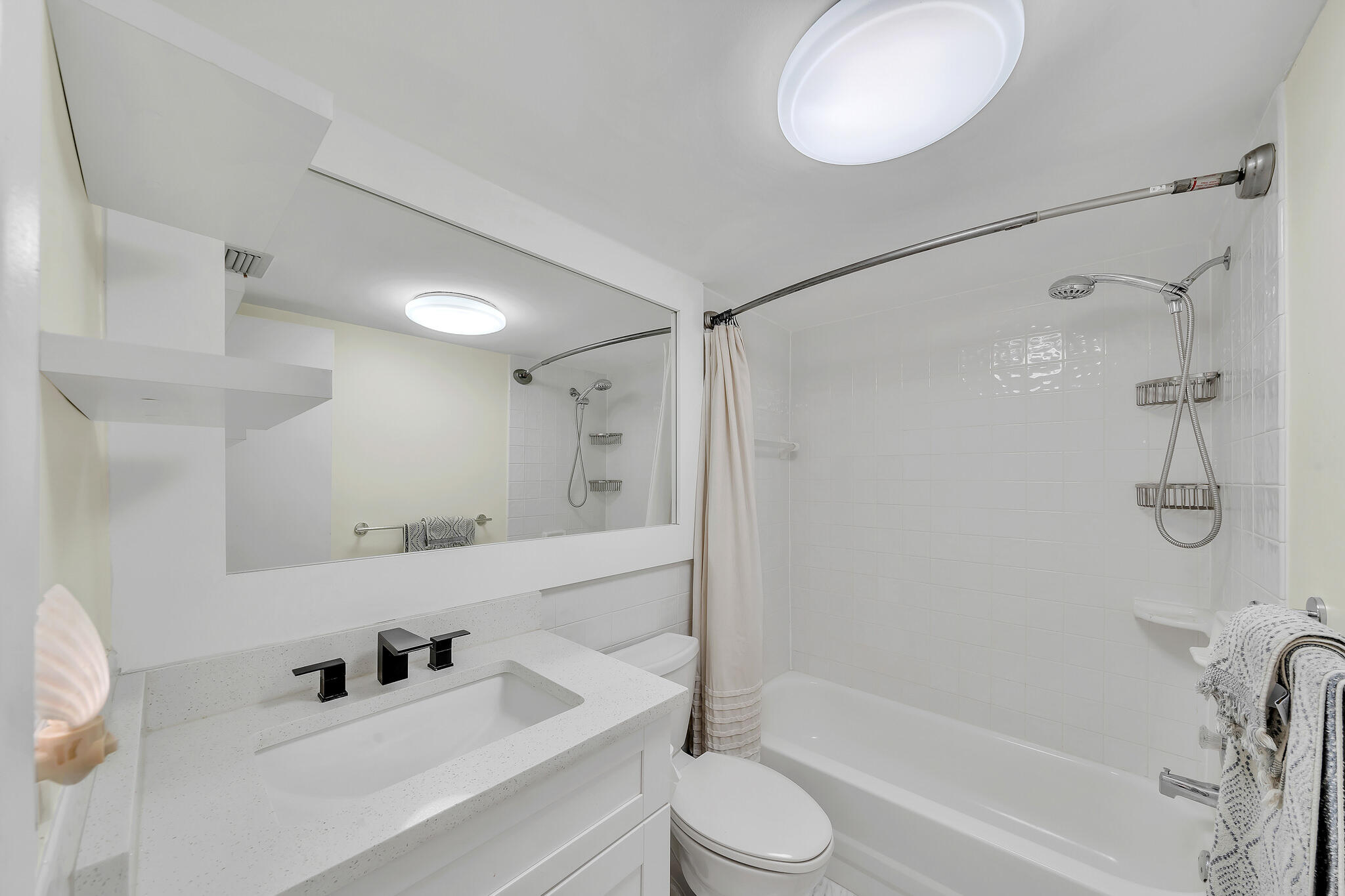 711 Northeast Harbour Terrace, Unit 3090 Boca Raton, FL 33431 - Photo 15 of 53 a bathroom with a bathtub shower sink vanity and toilet