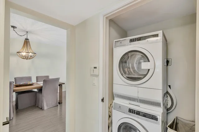 a view of kitchen with sink refrigerator dining table and chairs