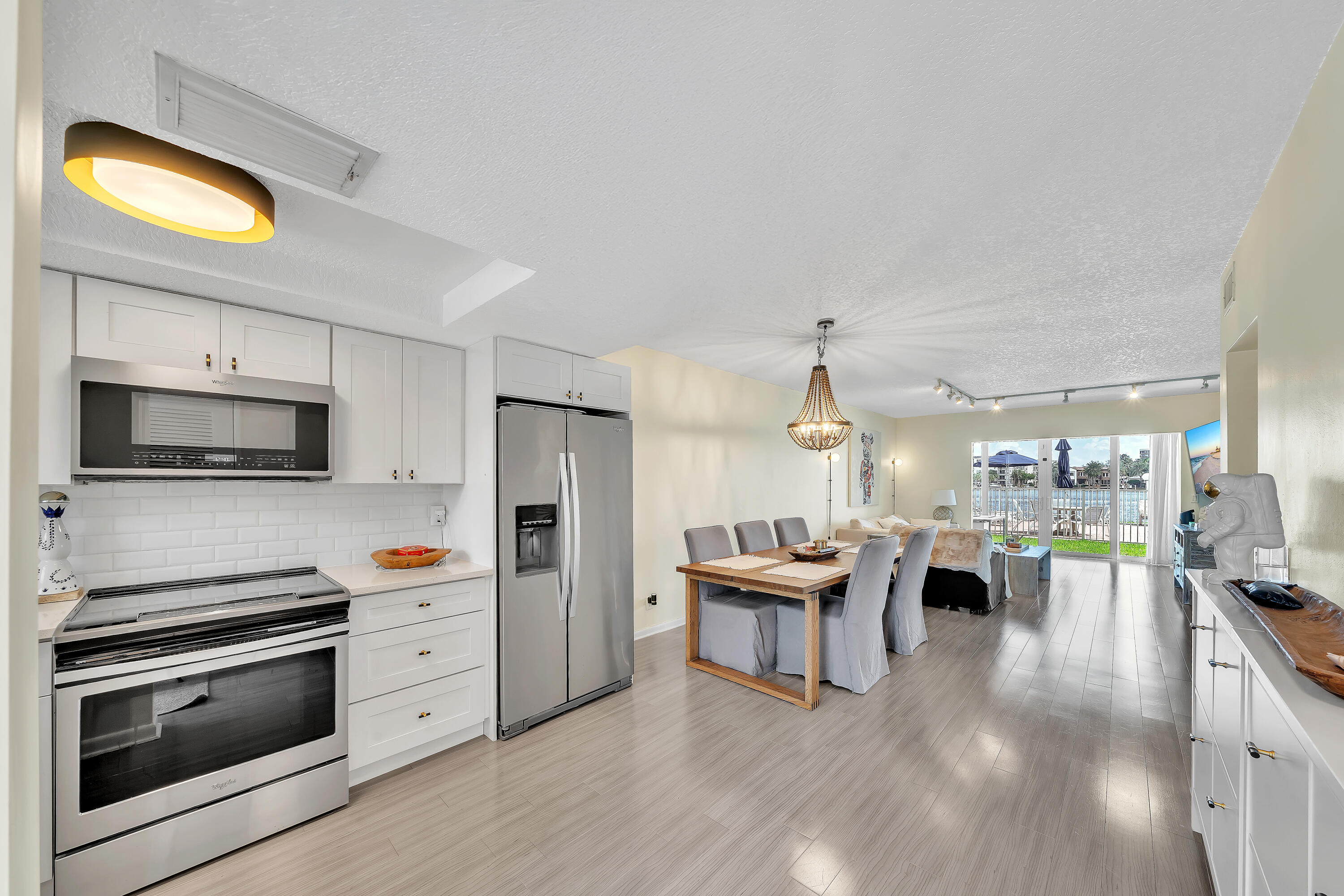 711 Northeast Harbour Terrace, Unit 3090 Boca Raton, FL 33431 - Photo 2 of 53 a kitchen with stainless steel appliances kitchen island granite countertop a stove and a sink