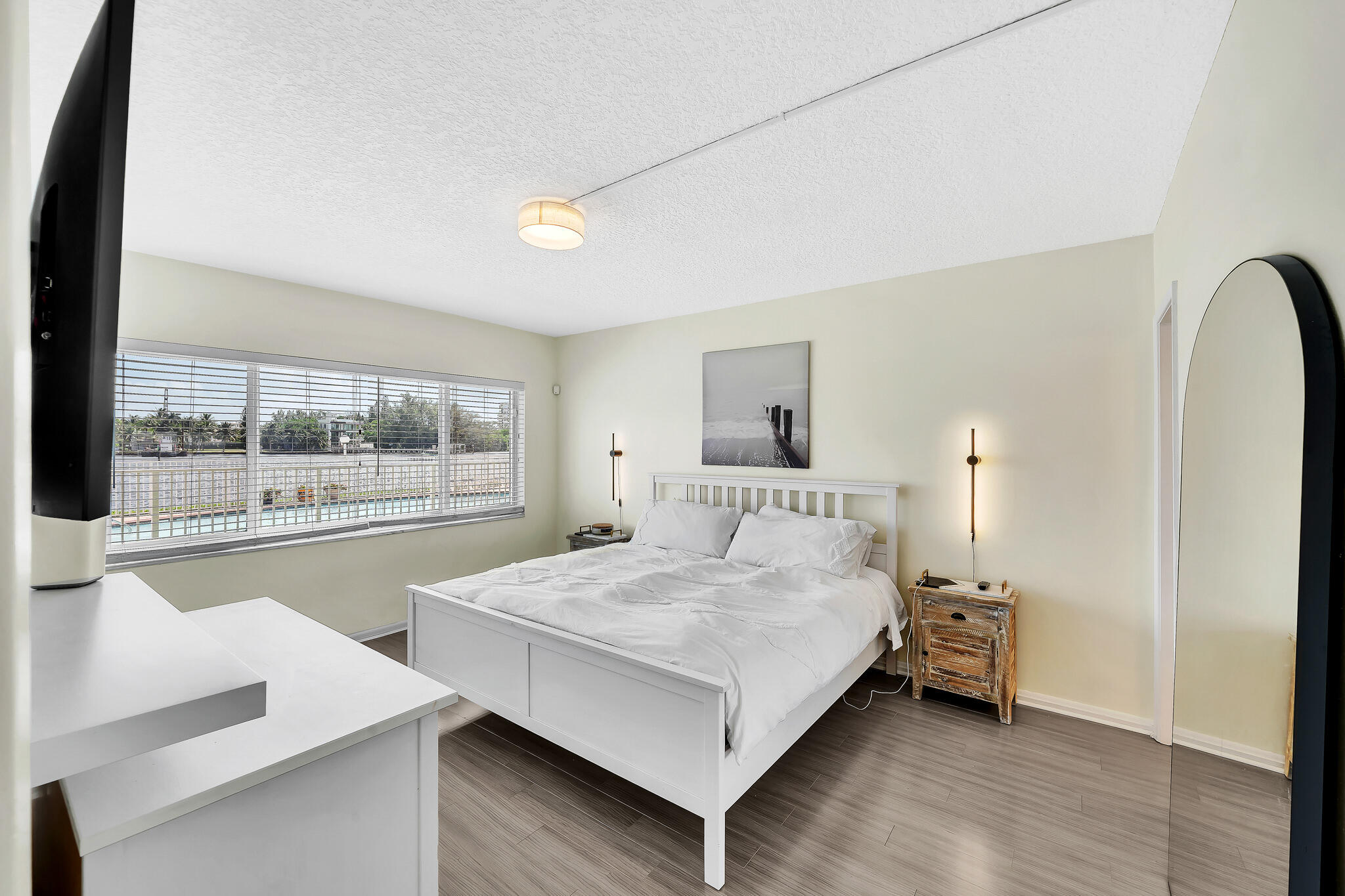 711 Northeast Harbour Terrace, Unit 3090 Boca Raton, FL 33431 - Photo 22 of 53 a bedroom with a bed and large window with outer view