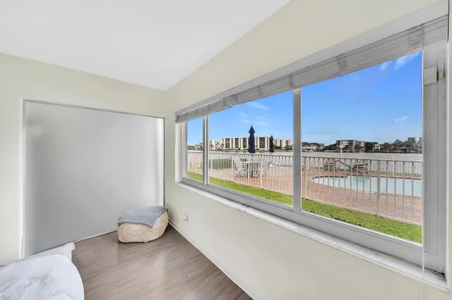 a bedroom with a bed and a view of kitchen