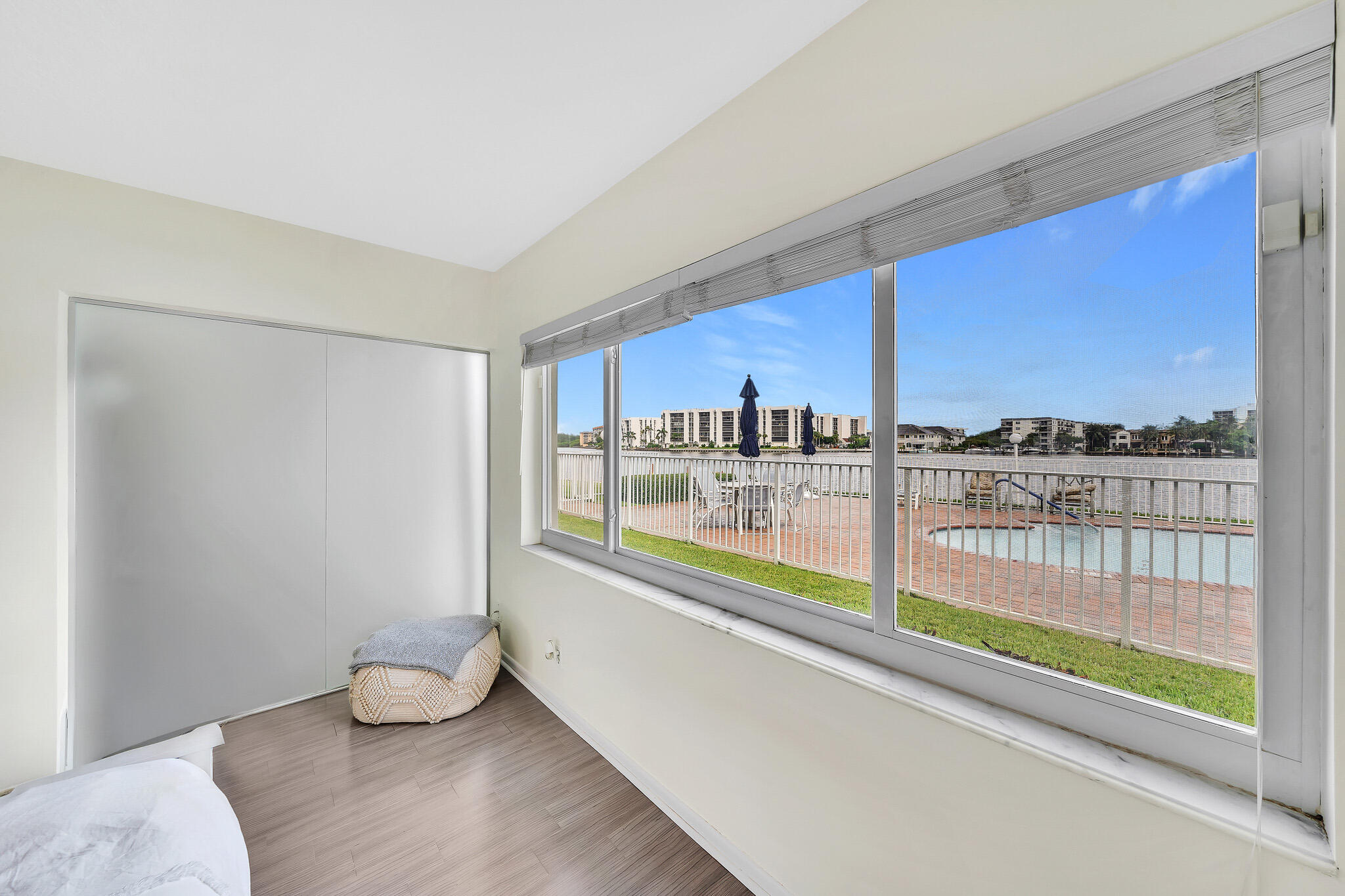 711 Northeast Harbour Terrace, Unit 3090 Boca Raton, FL 33431 - Photo 28 of 53 a kitchen with stainless steel appliances wooden floor and a large window